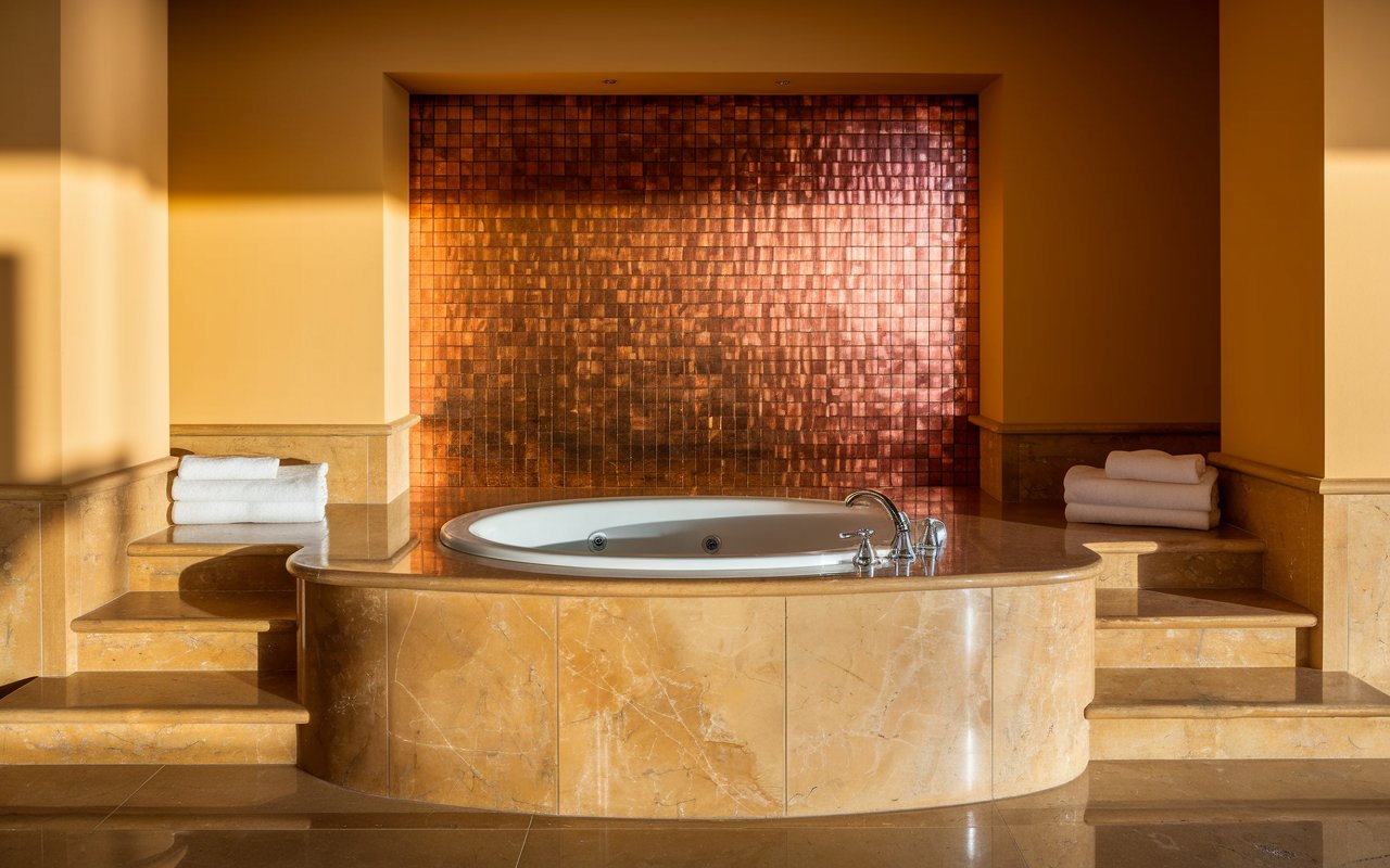 A spacious bathroom featuring a luxurious jacuzzi tub, perfect for relaxation and comfort.