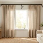 Floor-length curtains correctly installed high and wide above a living room window.