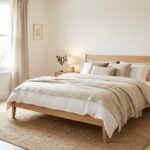 Cozy Scandinavian bedroom with wood bed frame and neutral linens
