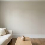 Living room with Benjamin Moore Edgecomb Gray HC-173 warm greige walls, ivory sofa, white trim, and natural oak flooring in soft daylight.